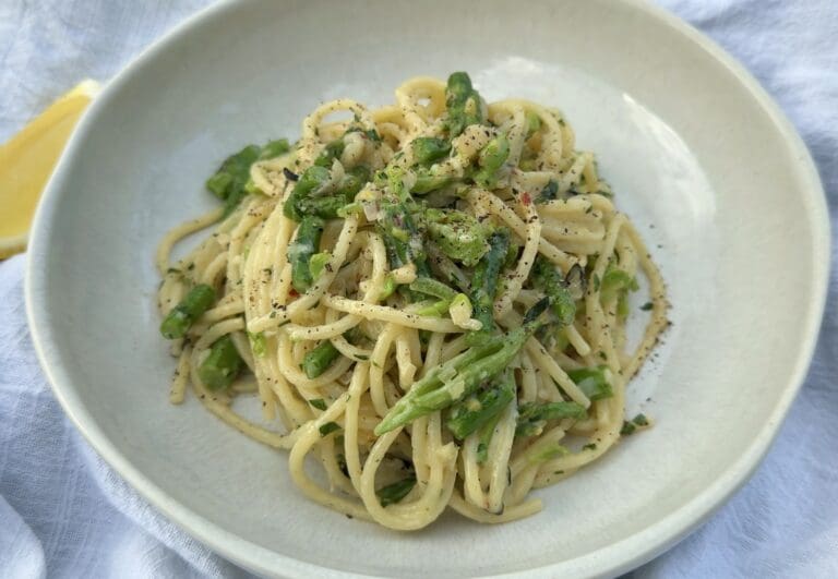 Plate of pasta with green vegetables