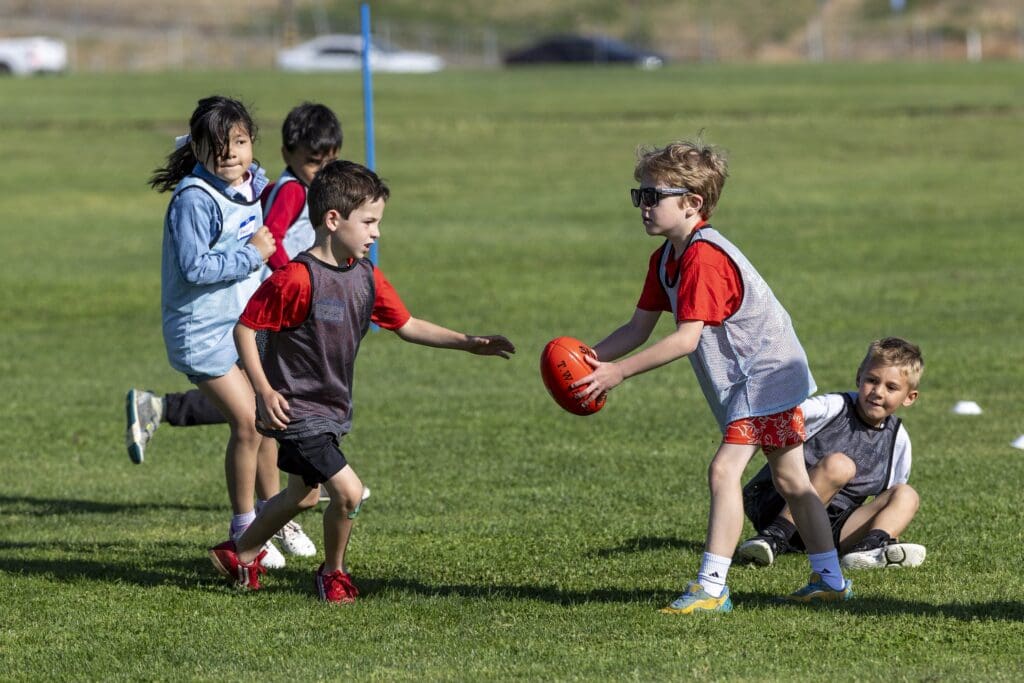 Kids play Australian football