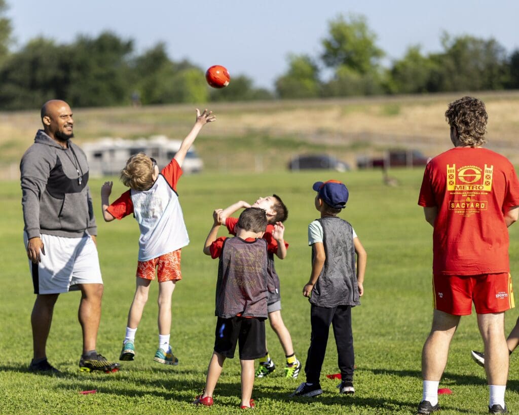 Kids play Australian football