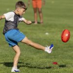 Kids play Australian football