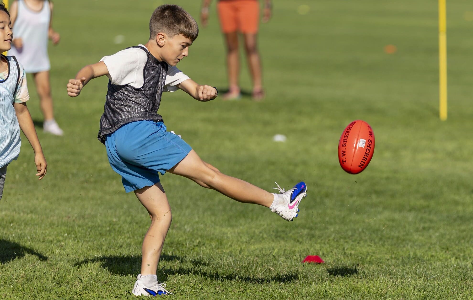 Kids play Australian football