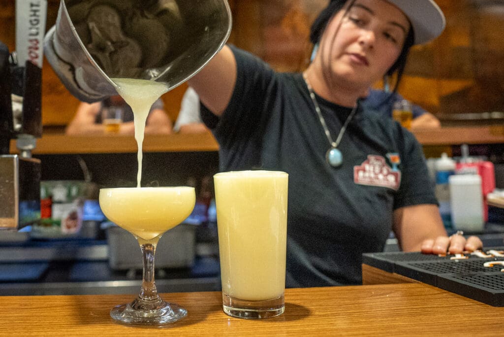 cocktail server pouring drink
