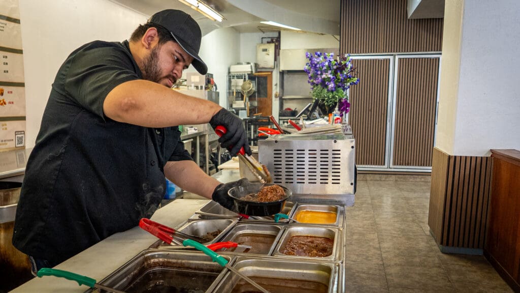 man making burrito bowl