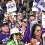 People holding signs at union rally