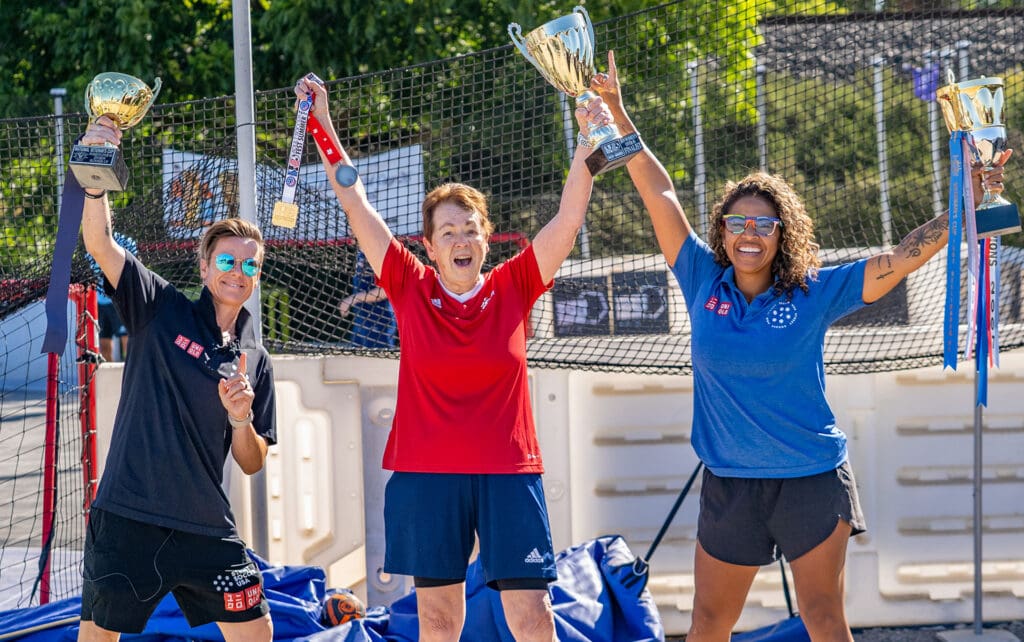 women holding trophies