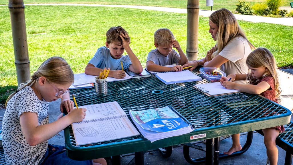 A mom and her children writing
