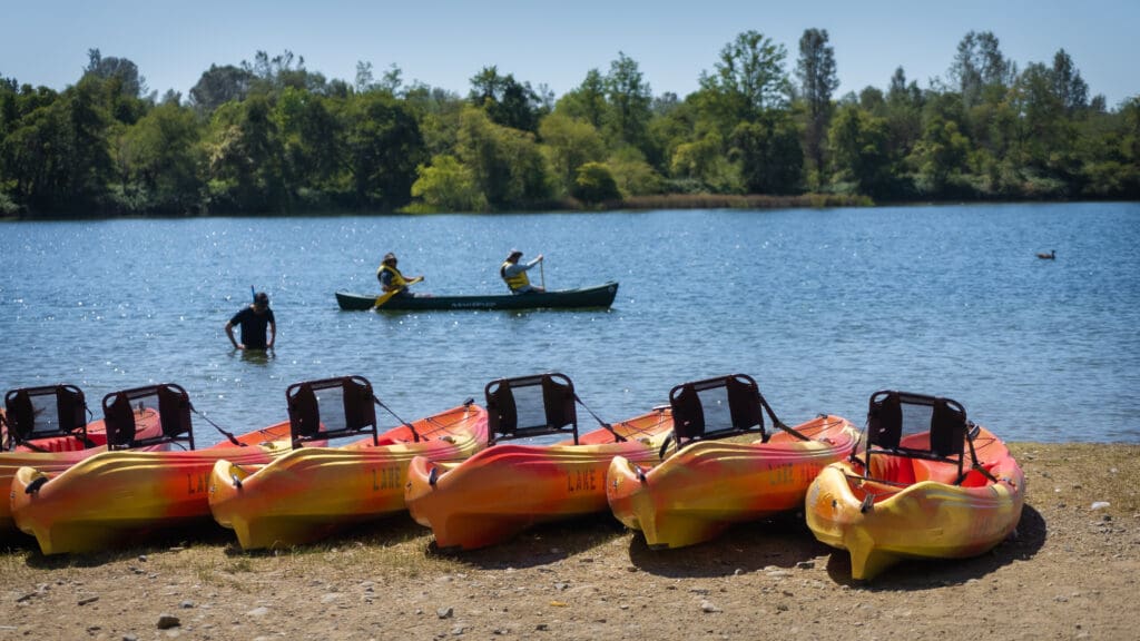 kayaks and kayakers at the lake