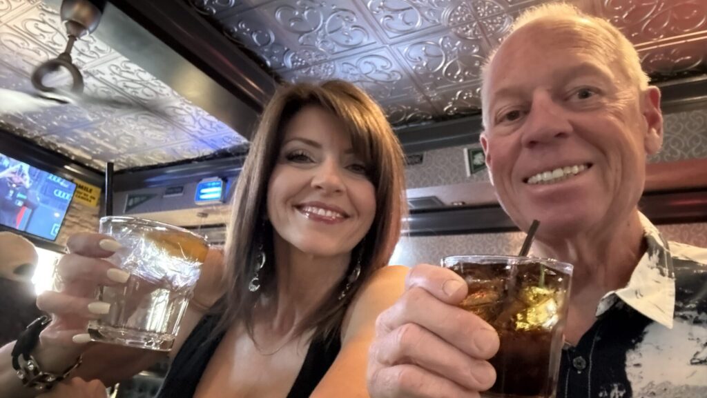 A couple holds drinks