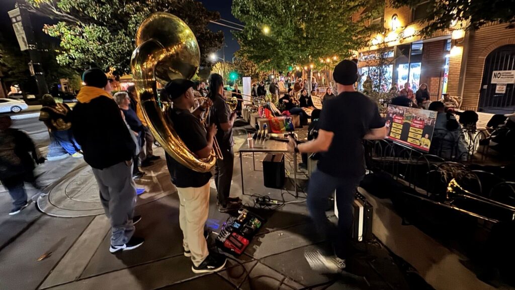 A band plays instruments on a stage