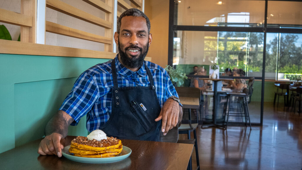 man sitting down with food