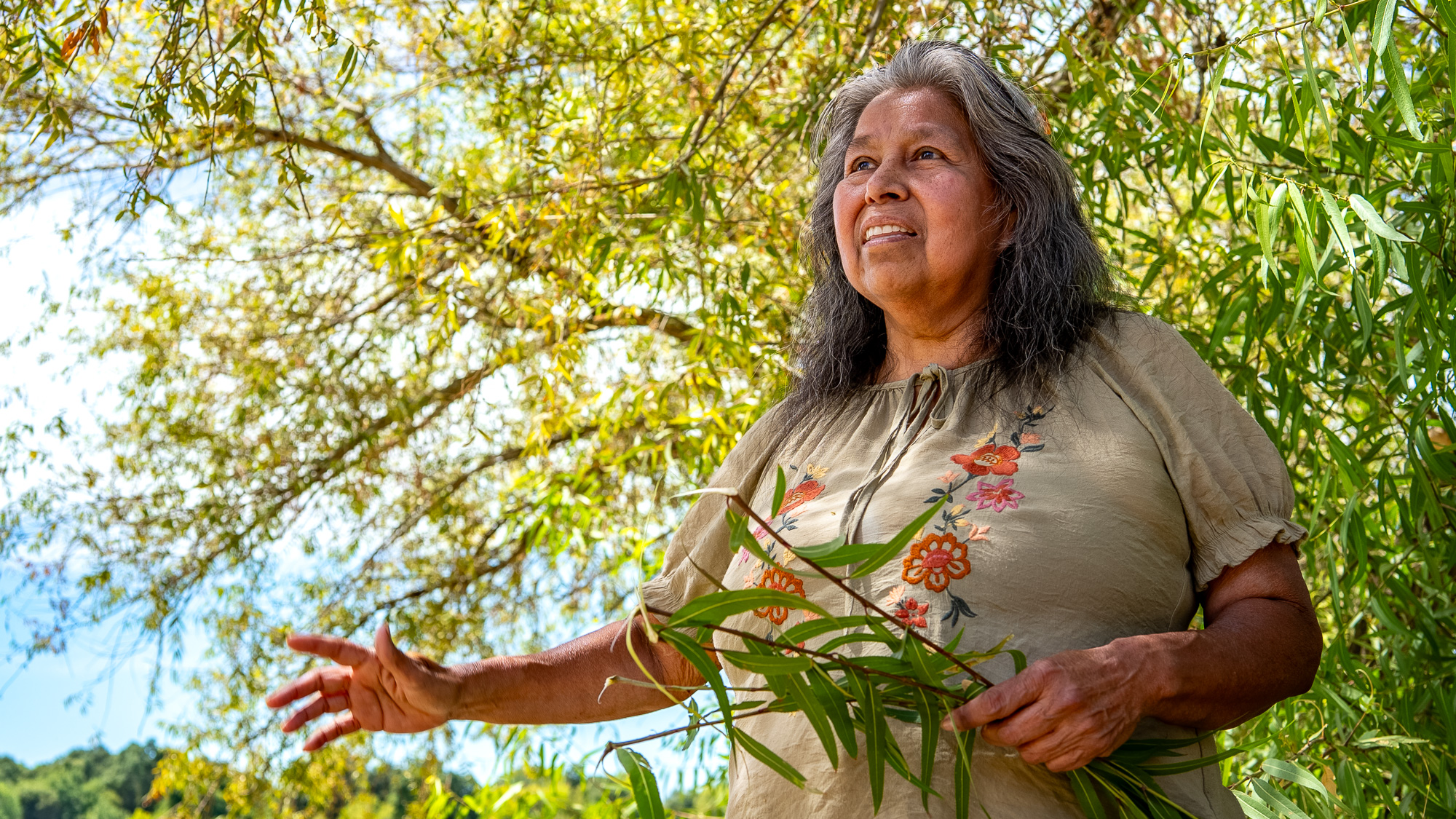 woman holding branch