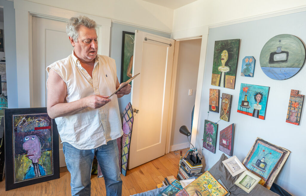 man looking at art