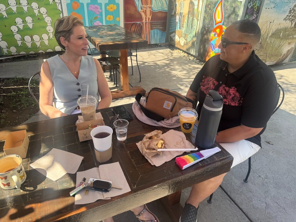 Two people sit at a table