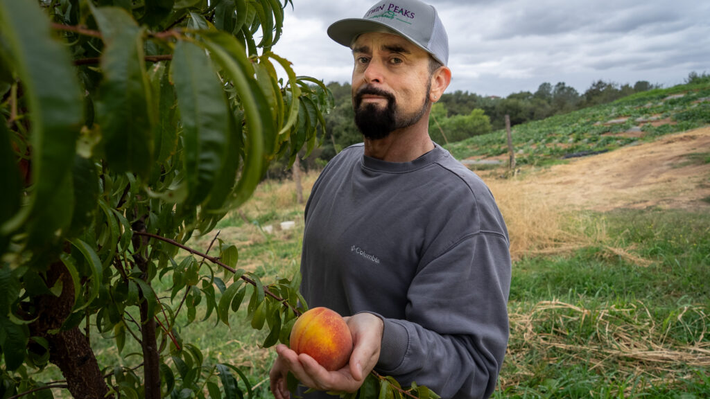 man holding peach