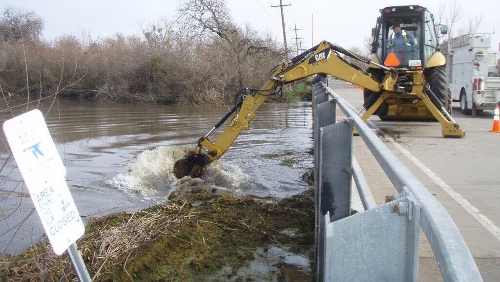 Backhoe clears debris