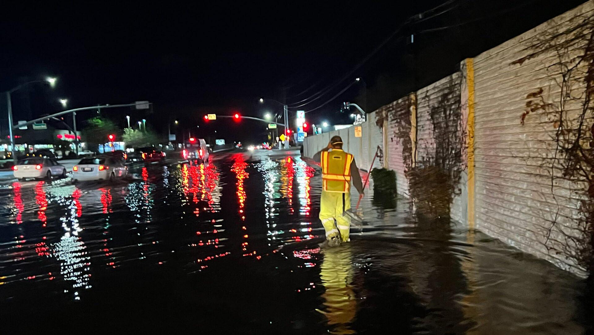 Man clears water on street