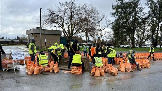 Sacramento County workers fill and prepare sandbags