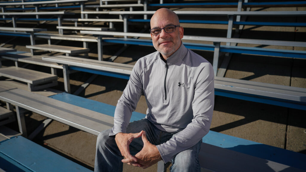Man seated in bleachers