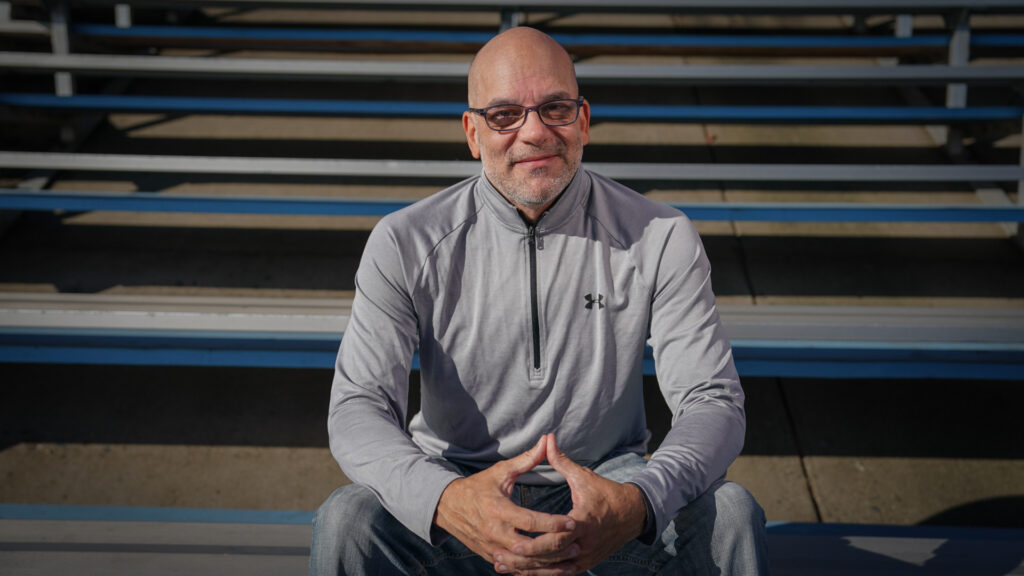 Man seated in bleachers