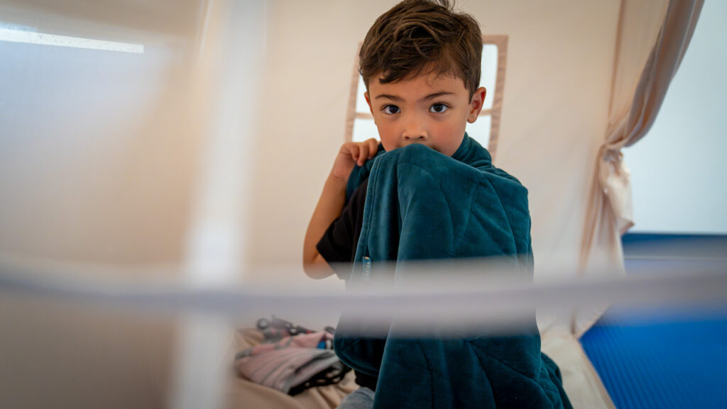 Kid holding a blanket