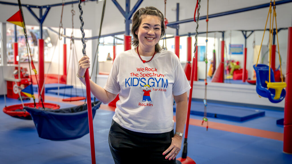 A woman stands in a gym