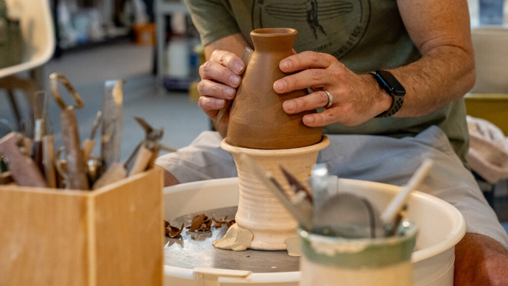 A person makes clay