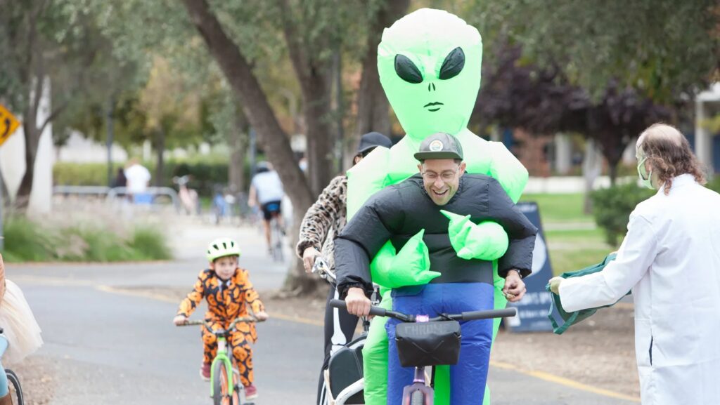 Man in costume rides bike