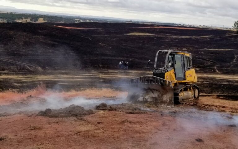 A bulldozer puts out a fire