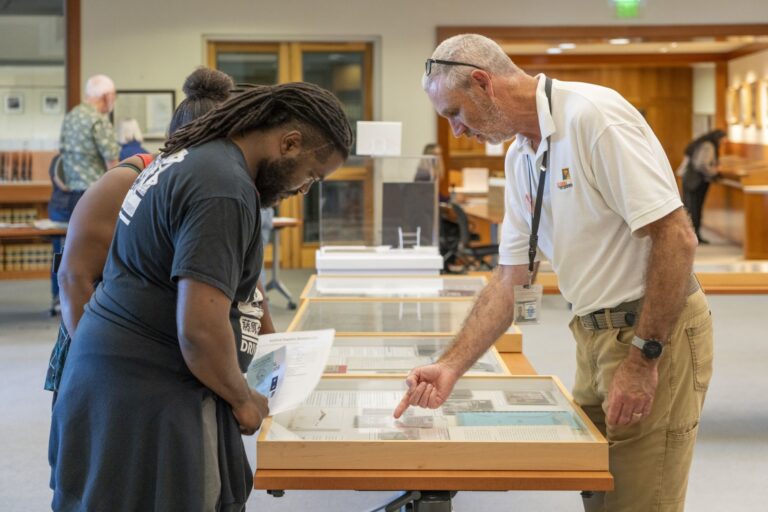 Man points to a glass case