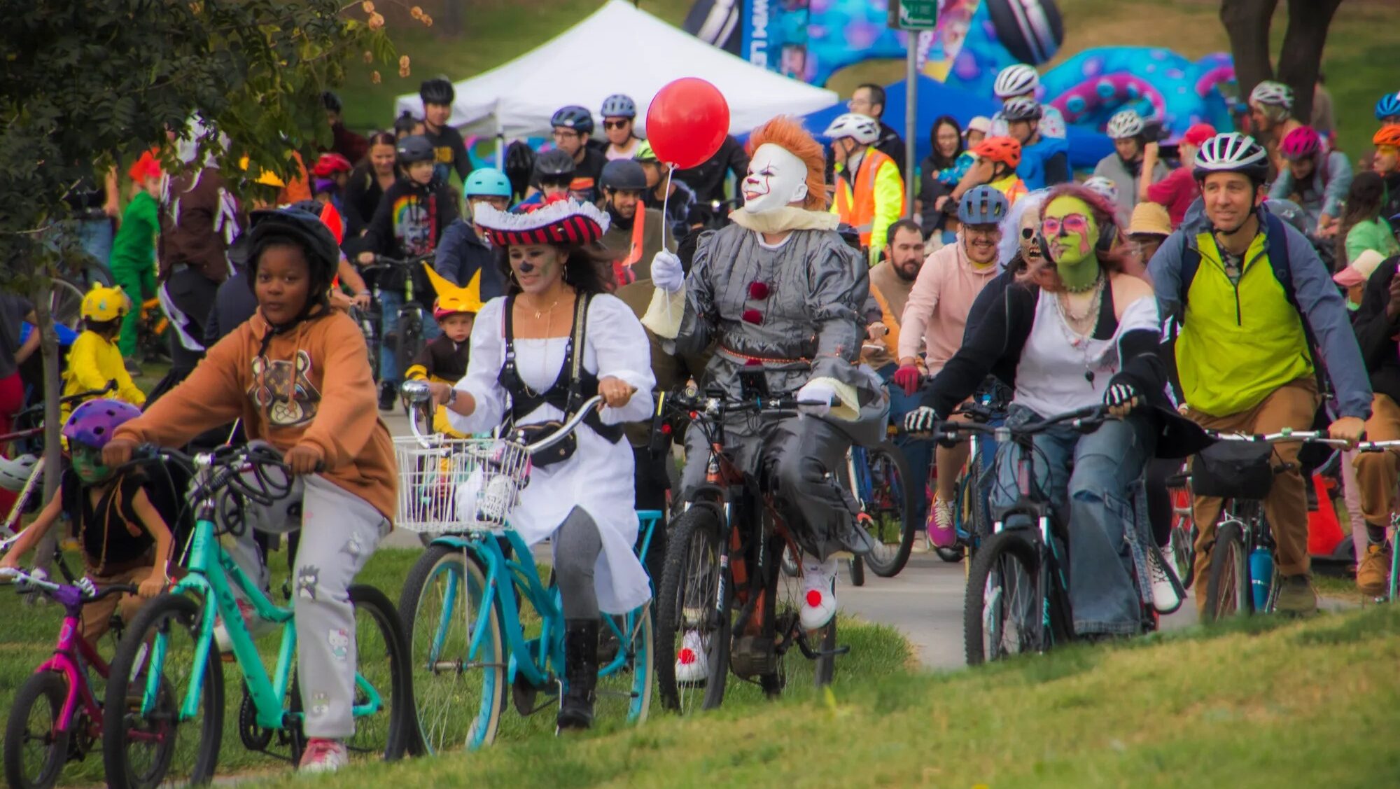 People in costume ride bikes